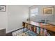 Office features a wooden desk and a light-filled window at 3011 Oneida St, Denver, CO 80207
