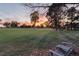 Serene backyard view at sunset overlooking a golf course at 6 Driver Ln, Littleton, CO 80123