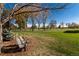 Relaxing backyard with two Adirondack chairs overlooking a golf course at 6 Driver Ln, Littleton, CO 80123