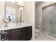 Modern bathroom with dark vanity and a walk-in shower at 6 Driver Ln, Littleton, CO 80123