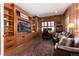 Spacious library with built-in bookshelves and a large TV at 6 Driver Ln, Littleton, CO 80123