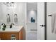 Bathroom with wood vanity, and walk-in closet with vase accents at 5555 E Briarwood Ave # 2604, Centennial, CO 80122