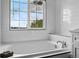 Modern bathroom with a white subway tile surround, soaking tub, and natural light, for a bright, clean aesthetic at 5555 E Briarwood Ave # 2604, Centennial, CO 80122