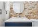 Close-up of a bathroom vanity with a stone accent wall and contemporary fixtures, offering a touch of modern design at 5555 E Briarwood Ave # 2604, Centennial, CO 80122