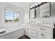 Elegant bathroom featuring a soaking tub, double vanity, and natural light, providing a spa-like experience at home at 5555 E Briarwood Ave # 2604, Centennial, CO 80122