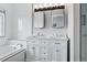 Elegant bathroom with a double vanity, tub, marble countertops, decorative mirrors and chrome fixtures at 5555 E Briarwood Ave # 2604, Centennial, CO 80122