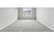 Bright bedroom featuring a large window and neutral-colored carpeting at 5555 E Briarwood Ave # 2604, Centennial, CO 80122