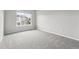 Bright bedroom featuring a large window and neutral-colored carpeting at 5555 E Briarwood Ave # 2604, Centennial, CO 80122