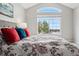 Comfortable bedroom featuring a floral duvet, large window, and neutral tones, offering a serene and relaxing retreat at 5555 E Briarwood Ave # 2604, Centennial, CO 80122