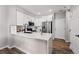 Modern kitchen with stainless steel appliances, white cabinetry, quartz countertops, and ample storage space at 5555 E Briarwood Ave # 2604, Centennial, CO 80122