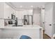 Well-lit kitchen with stainless steel appliances, white cabinets, and a breakfast bar for casual dining at 5555 E Briarwood Ave # 2604, Centennial, CO 80122