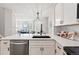 Bright kitchen featuring white cabinets, quartz countertops, and stainless steel appliances, with a view into the living area at 5555 E Briarwood Ave # 2604, Centennial, CO 80122