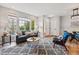 Bright living room with large windows, modern furniture, and a stylish gray patterned rug over vinyl flooring at 5555 E Briarwood Ave # 2604, Centennial, CO 80122
