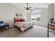 Sunlit bedroom with vaulted ceilings, a ceiling fan, a floral print duvet cover, and neutral gray carpet at 5555 E Briarwood Ave # 2604, Centennial, CO 80122