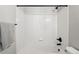 White tiled bathtub and shower with black fixtures at 5555 E Briarwood Ave # 2604, Centennial, CO 80122