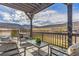 A covered patio sitting area provides an outside living space to enjoy the mountain views at 3377 S Quartz St, Morrison, CO 80465