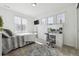 Bright bedroom with a plush rug, large windows, and a vanity with a lighted mirror at 3377 S Quartz St, Morrison, CO 80465