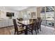 Bright dining area featuring hardwood floors, large windows, and access to an outdoor balcony at 3377 S Quartz St, Morrison, CO 80465