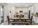 Stylish dining area with wood table and bench, open to a modern kitchen with stainless appliances at 3377 S Quartz St, Morrison, CO 80465