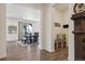 Open-concept dining room with wood floors, modern table, and bench seating, flowing into a spacious kitchen at 3377 S Quartz St, Morrison, CO 80465