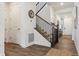 Bright entryway featuring hardwood floors, staircase with wrought iron railing, and a view into other rooms at 3377 S Quartz St, Morrison, CO 80465