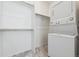 A compact laundry room with a stackable washer/dryer and storage space at 3377 S Quartz St, Morrison, CO 80465