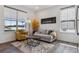 Bright living room featuring a neutral sofa, accent chair, and Denver skyline wall art at 3377 S Quartz St, Morrison, CO 80465