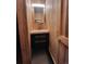 Modern bathroom with wood-paneled walls, a floating vanity with a vessel sink, and stylish lighting at 4568 Apex Valley Rd, Golden, CO 80403