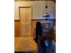 Hallway with wood details, stairway, and a decorative light fixture, showcasing rustic charm at 4568 Apex Valley Rd, Golden, CO 80403