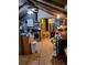 View of a rustic living room with exposed beams, wood floors, and an adjacent kitchen area at 4568 Apex Valley Rd, Golden, CO 80403