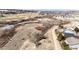 This aerial view showcases a green golf course and walking path with homes nestled in a serene setting at 23612 Glenmoor Dr, Parker, CO 80138