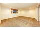 Versatile basement area with carpeted flooring, offering potential for a home theater or play area at 23612 Glenmoor Dr, Parker, CO 80138