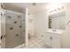 Clean bathroom offers walk-in shower with glass doors, tile floors and modern vanity at 23612 Glenmoor Dr, Parker, CO 80138