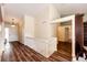 Bright entryway with hardwood floors, white walls and trim, a white staircase, and a view of the front door at 23612 Glenmoor Dr, Parker, CO 80138