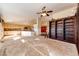 Open concept living room with a ceiling fan and view of the kitchen with island and a large wooden bookshelf at 23612 Glenmoor Dr, Parker, CO 80138