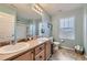 Ensuite bath featuring double sinks, soaking tub, large mirror, walk-in shower and modern fixtures at 277 Jewel St, Brighton, CO 80603