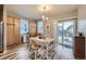 Bright dining area with a wooden table, slider access to backyard, and natural light at 277 Jewel St, Brighton, CO 80603