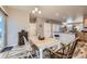 Open dining area with rustic wood floors, neutral walls, and easy access to kitchen at 277 Jewel St, Brighton, CO 80603