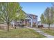 Beautiful two-story home with a cozy front porch, manicured lawn, and inviting curb appeal at 277 Jewel St, Brighton, CO 80603