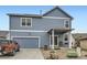 Exterior shot of the home showcasing the garage, patio, and landscaped backyard at 277 Jewel St, Brighton, CO 80603