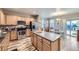 Open kitchen featuring stainless appliances, marble counters and island, and wood-look flooring at 277 Jewel St, Brighton, CO 80603