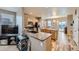 Open kitchen featuring stainless appliances, marble counters and island, and wood-look flooring at 277 Jewel St, Brighton, CO 80603