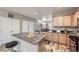 Open kitchen featuring stainless appliances, marble counters and island, and wood-look flooring at 277 Jewel St, Brighton, CO 80603