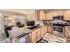 Bright kitchen with stainless appliances, double sink, marble counters and wood-look flooring at 277 Jewel St, Brighton, CO 80603