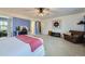 Large main bedroom featuring a sitting area, carpet flooring, ceiling fan and ensuite bath at 277 Jewel St, Brighton, CO 80603