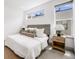 Cozy bedroom with large windows providing natural light, soft carpet and neutral accents at 3008 Blake St, Denver, CO 80205