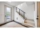 Bright entryway with a modern staircase featuring sleek black metal railings and light wood stairs at 3008 Blake St, Denver, CO 80205