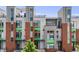 Contemporary townhouse featuring a red brick facade, sleek gray accents, and a rooftop terrace at 3008 Blake St, Denver, CO 80205