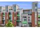Modern townhouse showcasing clean lines, a brick facade, and upper-level outdoor balconies and rooftop terrace at 3008 Blake St, Denver, CO 80205