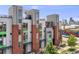 Contemporary townhouse with brick accents, rooftop terrace, and views of the city skyline in the background at 3008 Blake St, Denver, CO 80205